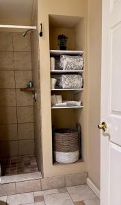 a bathroom with a closet with towels in it at Hotel Belvidere in Belvidere