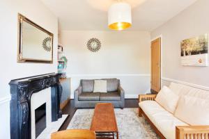 a living room with a couch and a fireplace at Leeds Home Away from Home with parking in Headingley
