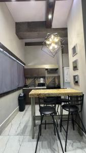 a dining room with a table and chairs in a kitchen at Gran Hotel Cantera La plaza in Nuevo Laredo