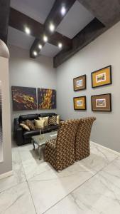 a living room with a couch and a table at Gran Hotel Cantera La plaza in Nuevo Laredo