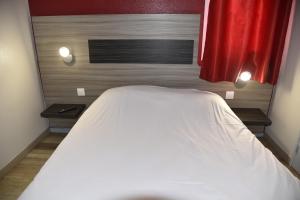 Postel nebo postele na pokoji v ubytování Hotel du Triangle