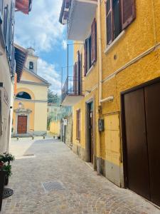 an alley between two buildings on a street at Rossi Lake Couple in Oliveto Lario +14 photos