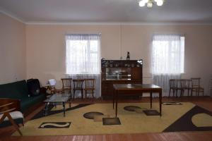 a living room with a couch and a table and chairs at Вила Eco Garden in Gyumri