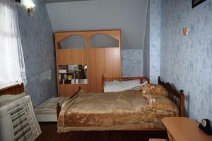 a bedroom with a bed with a wooden headboard at Вила Eco Garden in Gyumri