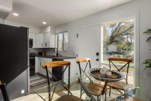 a kitchen with a glass table and two chairs at Modern Townhouse-Walk 2 OldTown-4 Heated Pools in Scottsdale