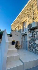a house with stairs leading up to a building at Meraki house of kalymnos Apartments in Kalymnos