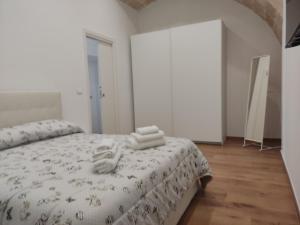a bedroom with a bed with towels on it at Dimora Gassi White in Mola di Bari +9 photos