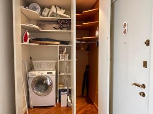 a laundry room with a washer and dryer at BELLE ILE LAKE VIEW SUITE in Griante Cadenabbia