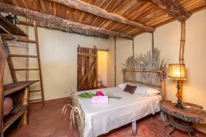 a bedroom with a bed in a room with wooden ceilings at Tylers Place Home in Coco