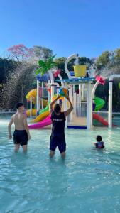 two people playing in the water at a water park at Rafain Palace Hotel & Convention Center in Foz do Iguaçu