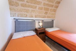 En eller flere senger på et rom på Villetta Jasmine con giardino Torre Pali