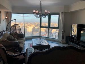 a living room with a view of a city at In the clouds in Alexandria