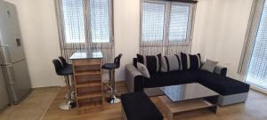 a living room with a couch and a chair at West Gate Apartments Ohrid in Ohrid