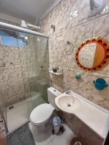 a bathroom with a toilet and a sink and a shower at Villa Madeira in Alto Paraíso de Goiás +67 photos
