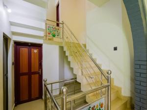 escalera en un edificio con puerta de madera en OYO Flagship Aiswarya Residency, en Wayanad