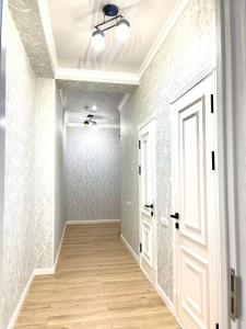 an empty hallway with a door and a ceiling at Residential Complex «Yunusabad - Khon Saroy» in Tashkent