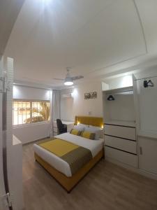 a bedroom with a large bed and a desk at Piscine privative et prestations haut de gamme in Dakar
