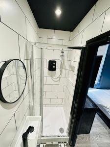 a bathroom with a shower with a sink and a mirror at Luxury Room, Central London, Ideal for Tourists in London