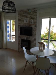 a living room with a table and chairs and a fireplace at Apartamento Pepa Bajondillo in Torremolinos