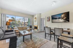 a living room with a couch and a table at Edelweiss Haus by All Seasons Resort Lodging in Park City