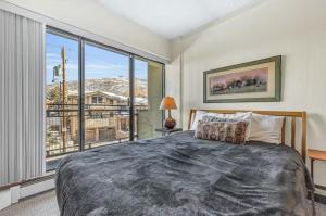a bedroom with a bed and a large window at Edelweiss Haus by All Seasons Resort Lodging in Park City +33 photos