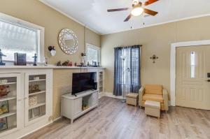 a living room with a tv and a ceiling fan at Cozy Vicksburg Home with Patio about 1 Mi to Riverfront! in Vicksburg
