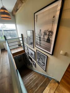 a hallway with a staircase with pictures on the wall at Vintage Villa B&B in Jastrzębia Góra
