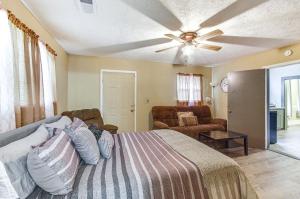 a bedroom with a bed and a ceiling fan at Cozy Vicksburg Home with Patio about 1 Mi to Riverfront! in Vicksburg