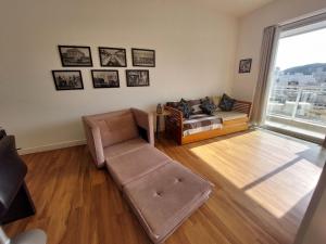 a living room with a couch and a chair at Book Santos - Unlimited 1709 - Apartamento Vista Mar in Santos