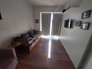 a living room with a couch and a window at Book Santos - Unlimited 1709 - Apartamento Vista Mar in Santos