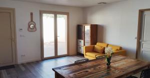 a living room with a yellow couch and a table at maison_du_sud_13140 in Miramas