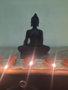 a statue of a woman sitting in a meditation pose at Gokul PG Homestay in Gorakhpur