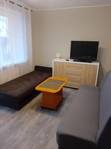 a living room with a couch and a coffee table at OLEŃKA in Darlowko +20 photos