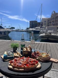 a table with a pizza and other food on it at Séjour au port in Hyères