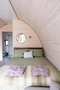 a bed in a room with two purple blankets at Coolaness Glamping in Irvinestown