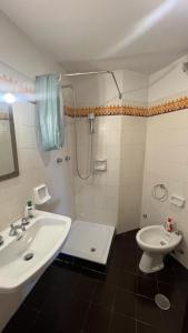 a bathroom with a sink and a toilet and a shower at Residence Le Verande 1 in San Massimo