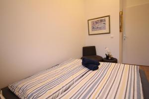 a bedroom with a bed with a blue towel on it at Spacious Apartment in Liesing Area LV4 in Vienna