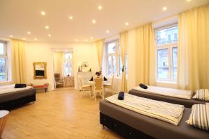 a room with beds and a dining room with a table at Spacious Apartment in Liesing Area LV4 in Vienna