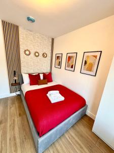 a bedroom with a red bed with a red blanket at R1 - Newly renovated Private Self contained Room in Selly Oak Birmingham with bathroom shared between two rooms in Birmingham +12 photos