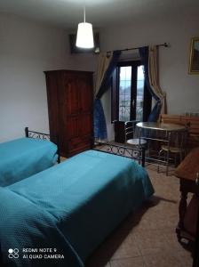 a bedroom with two beds and a table and a table at The Wishing Well in Gallinaro