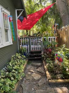 a porch with a red sheet on a house at Lovely Studio Apartment with Kitchenette. in Tampa
