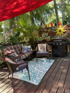 a patio with a couch and chairs and a piano at Lovely Studio Apartment with Kitchenette. in Tampa
