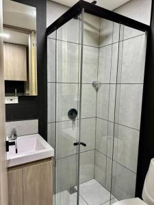 a bathroom with a shower with a sink and a toilet at Loft Belmont Suites 202 in Pereira