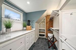 a large kitchen with white cabinets and a window at Hand House in Boise