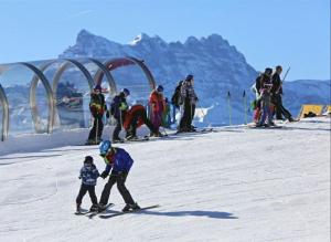 a group of people on skis in the snow at Chez Juliette in Leysin