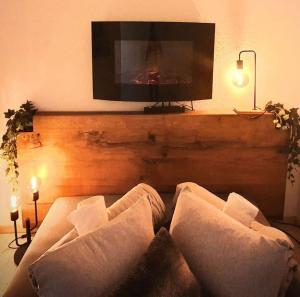 a living room with a couch and a flat screen tv at Chez Juliette in Leysin