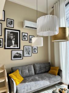 a living room with a couch and pictures on the wall at Casa Kashubia in Brzeźno Szlacheckie
