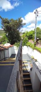 a bridge over a road with some stairs at Hostel do Coreto in Mucugê