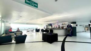 a lobby of a building with people sitting in chairs at A2-stunning Seaview 4brs3baths Duplex karon City in Ban Karon +74 photos