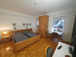 a bedroom with a bed and a table in it at ABM Apartment 14 in Zwingenberg